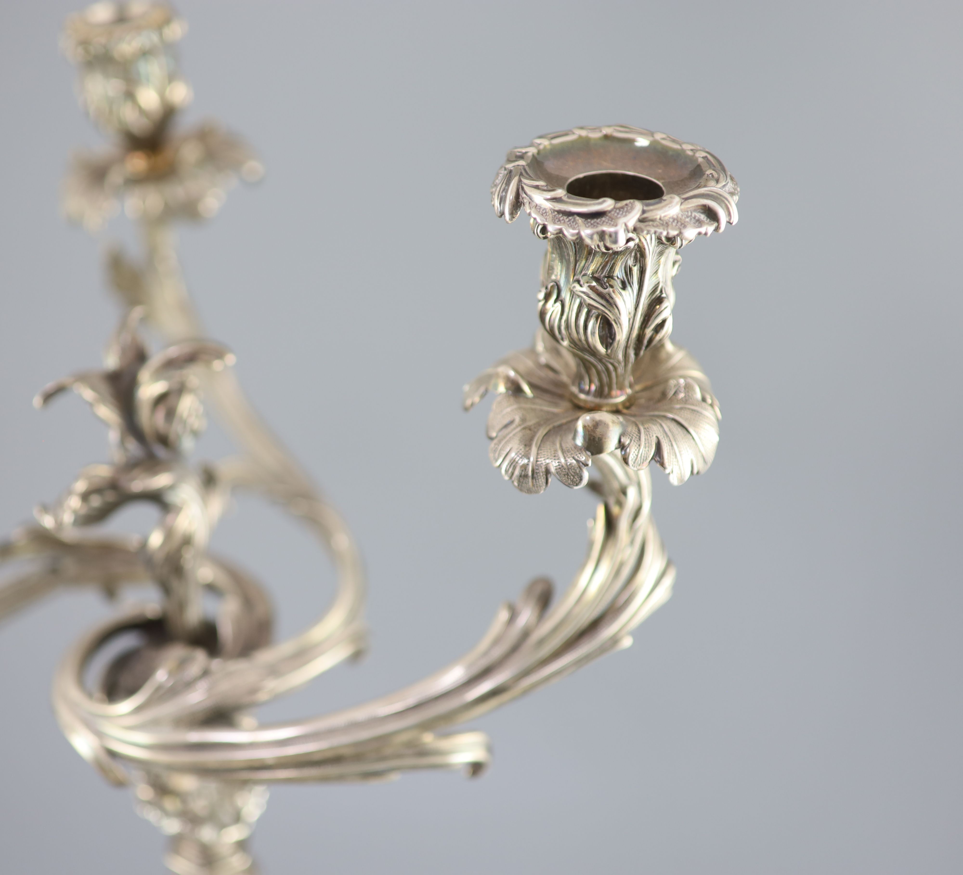 An ornate George III silver three branch, three light candelabrum, by Samuel Roberts, George Cadman & Co (a.f.),